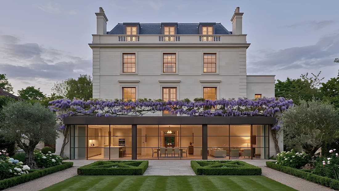Home extension in Holland Park, London — wisteria-clad stucco facade; glazed rear extension opening onto a landscaped garden, by Sovran Group